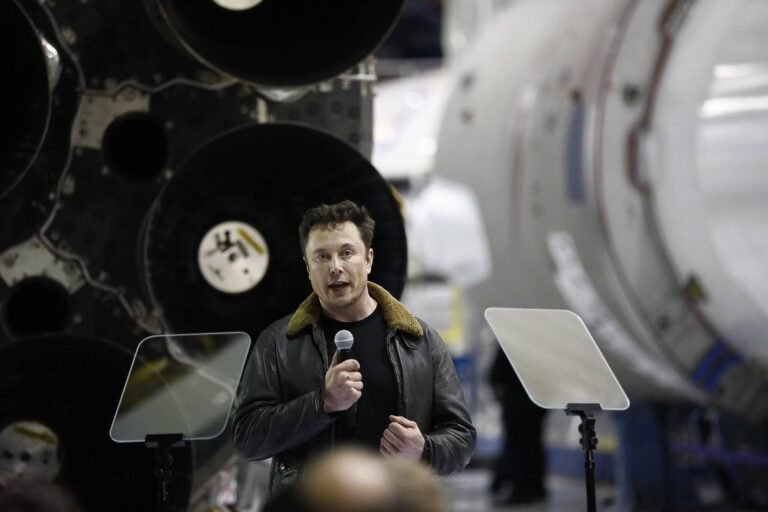 Elon Musk standing in front of a SpaceX rocket representing the world's first trillionaire and the potential $75 billion SpaceX IPO.